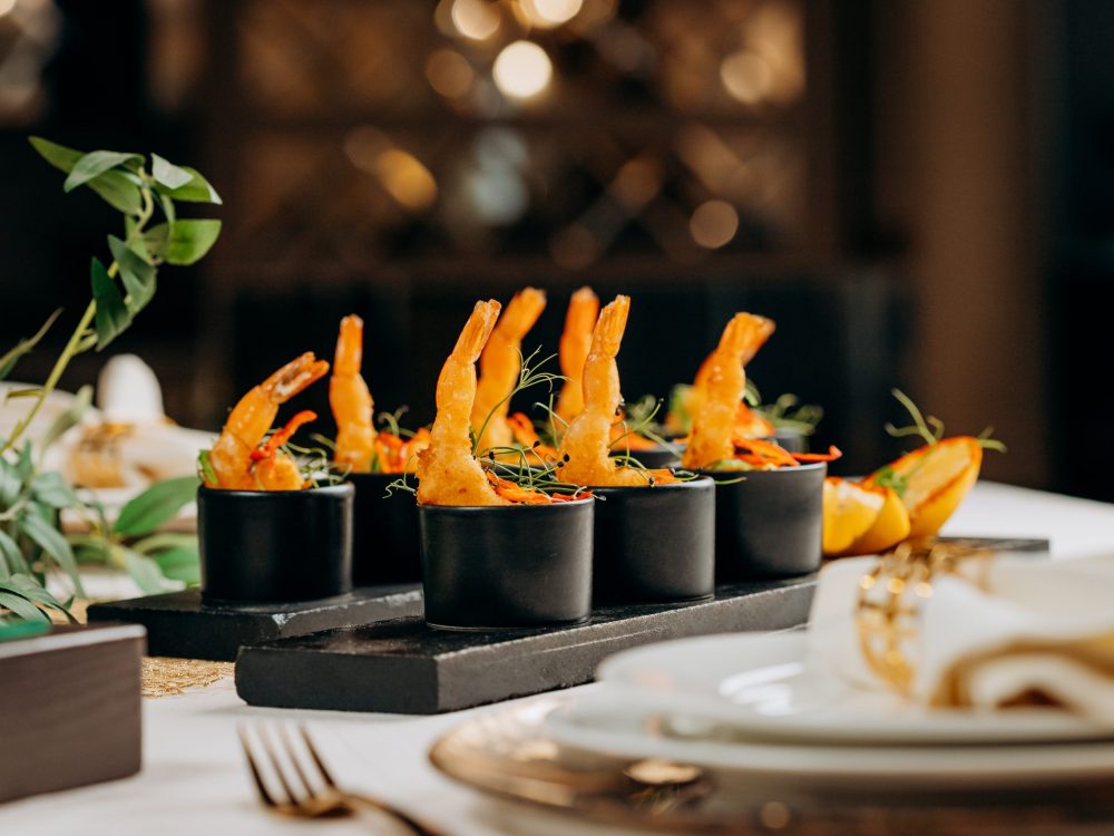 Fried tiger shrimps in breadcrumbs served with mango sauce ready for furshet in restaurant. Seafood, shellfish